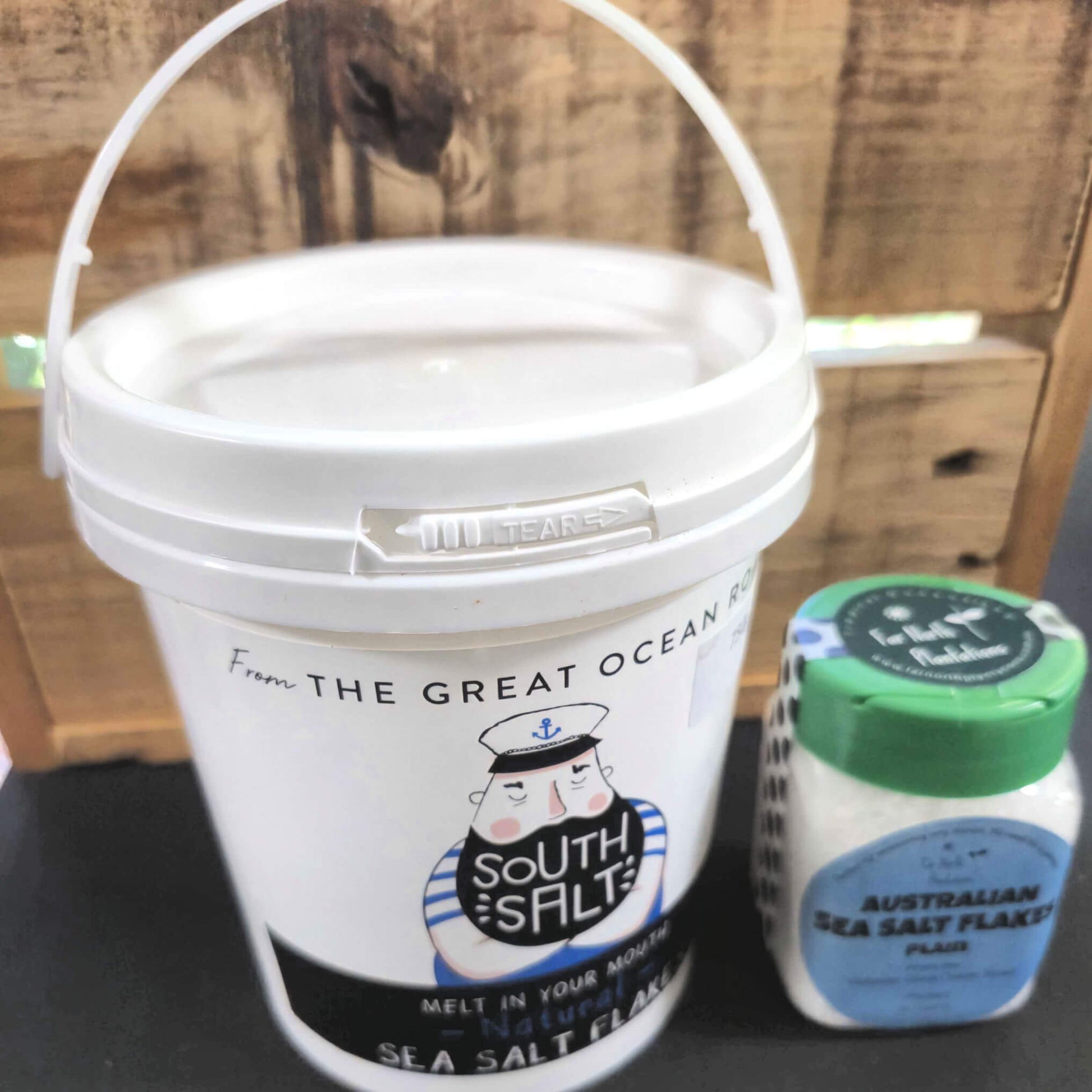 Australian Sea Salt Flakes in white bucket with sailor logo plus smaller shaker pack with green lid